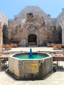 Serene courtyard at a historic caravanserai with central fountain.
